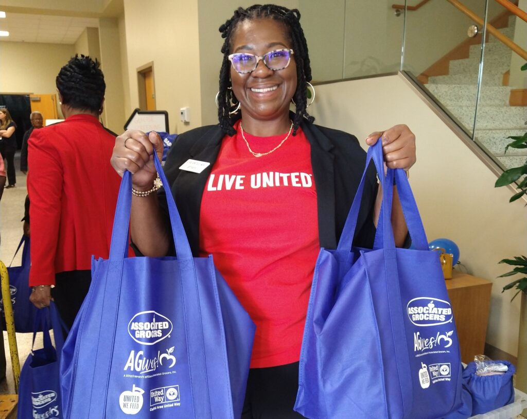 United Way Volunteer Holding AGives! bags at Women's Empowerment Event