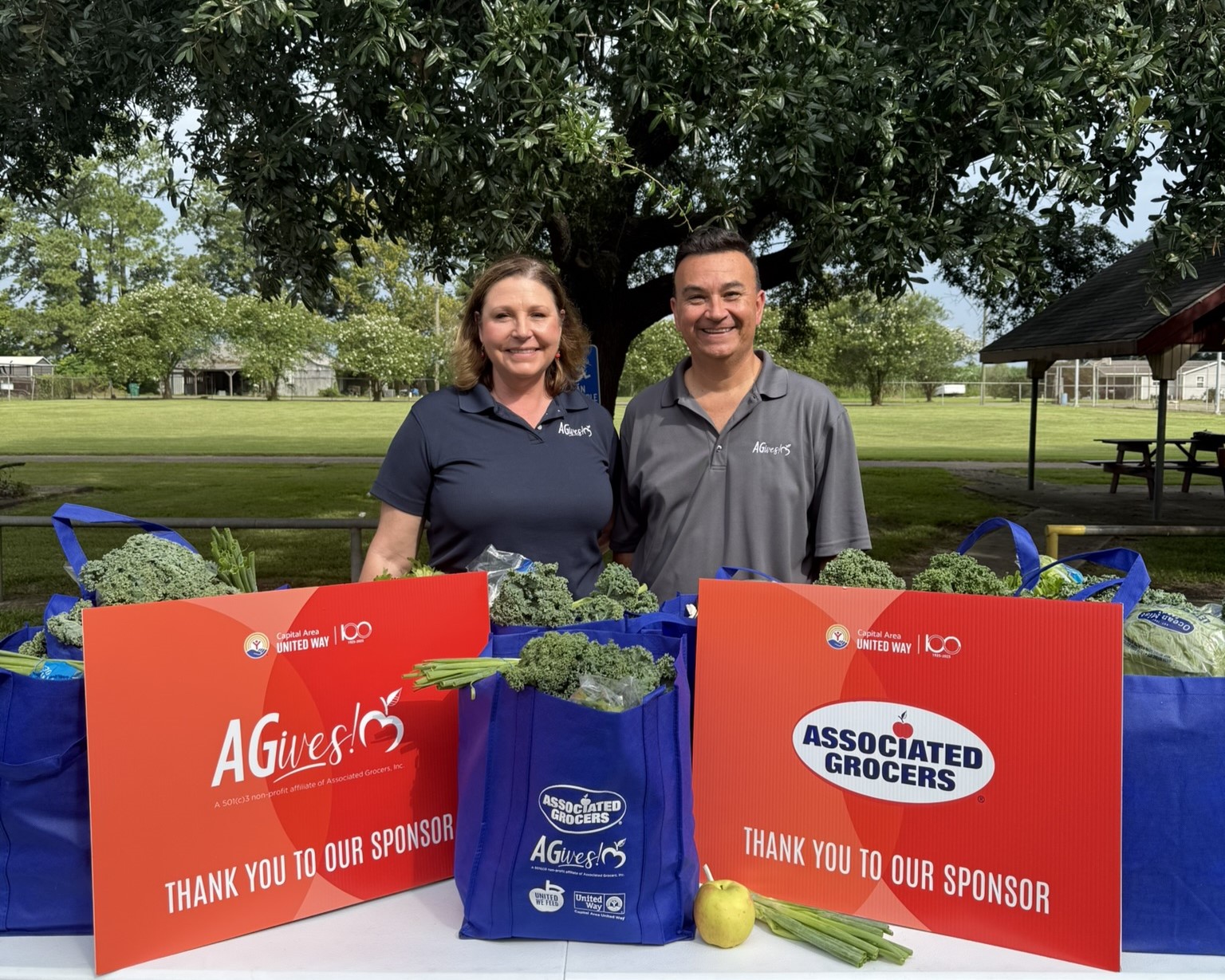 Two smiling Associated Grocers employees from the AGives! community program.
