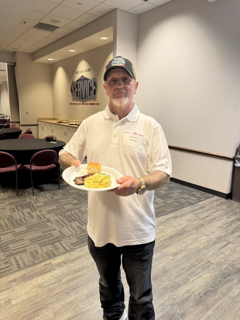Certified Angus Beef® training attendee enjoying a meal sample during a networking and educational event.